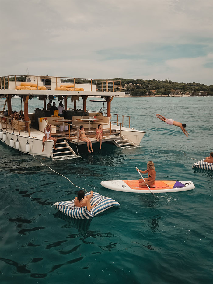 Floating beach club atmosphere during Utopia Catamaran afternoon cruise in Gili island.