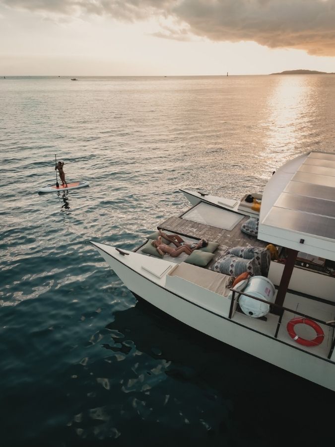 Utopia Catamaran anchored in clear turquoise water near the Gili Islands
